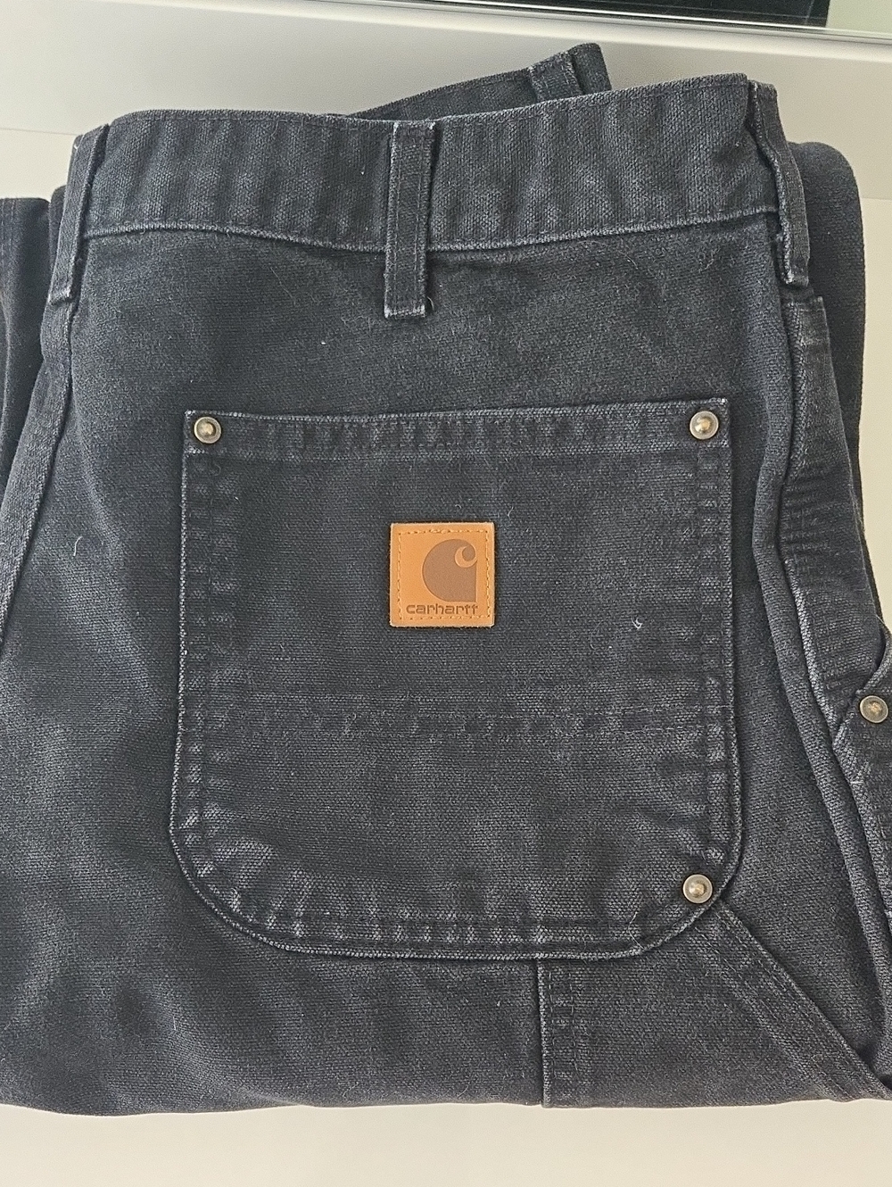 Carhartt Men’s Black Relaxed Fit Work Jeans with Tan Leather Patch